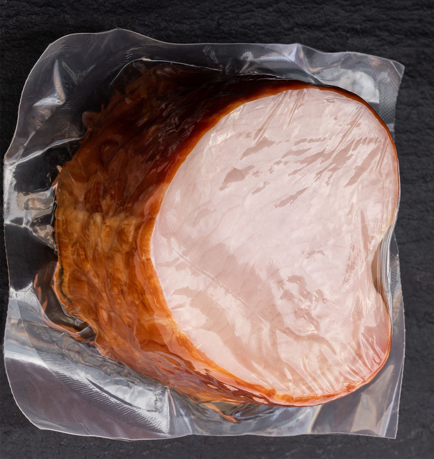 Typical applications for thermoforming films produced using Kuhne’s Triple Bubble® process include transport packaging for large pieces of meat or cheese. lena_zajchikova